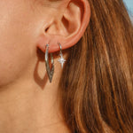 sterling silver celestial Dainty shooting star hoop Earrings with cubic zirconias being worn