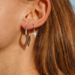 sterling silver celestial Dainty shooting star hoop Earrings with cubic zirconias being worn