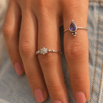 lifestyle image of a finger wearing a sterling silver CZ snowflake ring