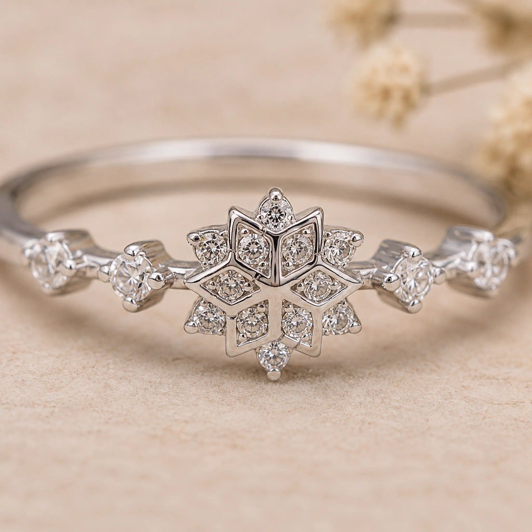 close up show of a sterling silver CZ snowflake Ring on a light surface