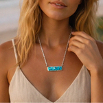woman wearing a turquoise necklace at the beach