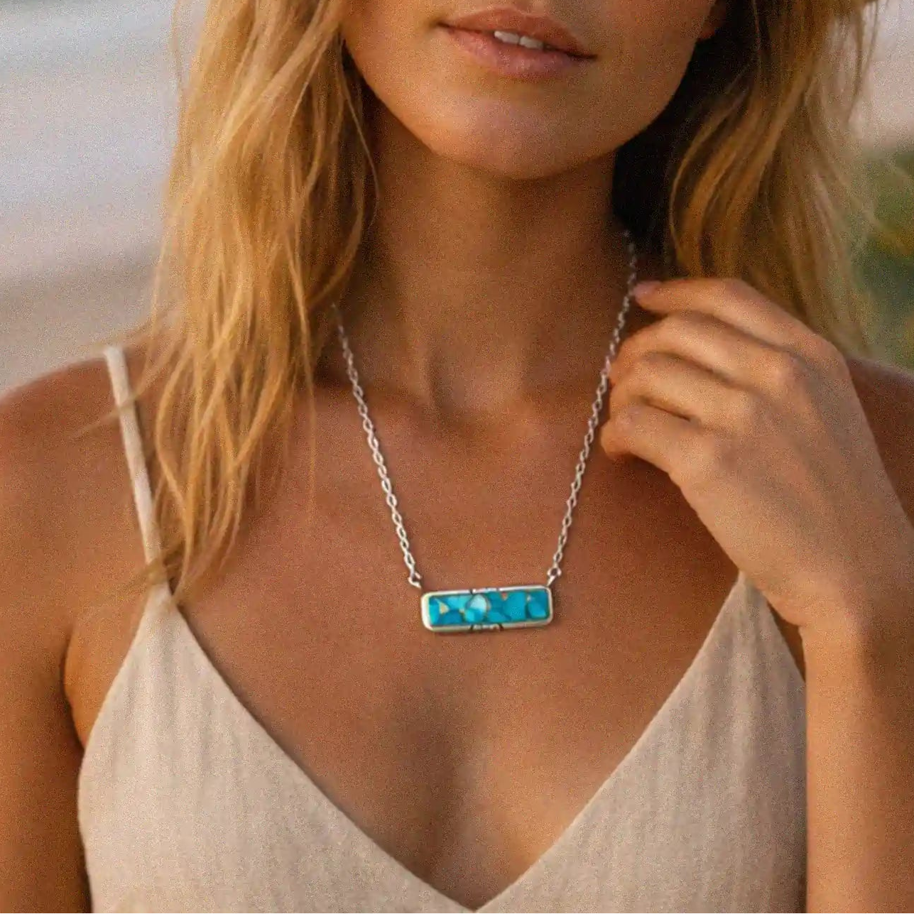 woman wearing a turquoise necklace at the beach