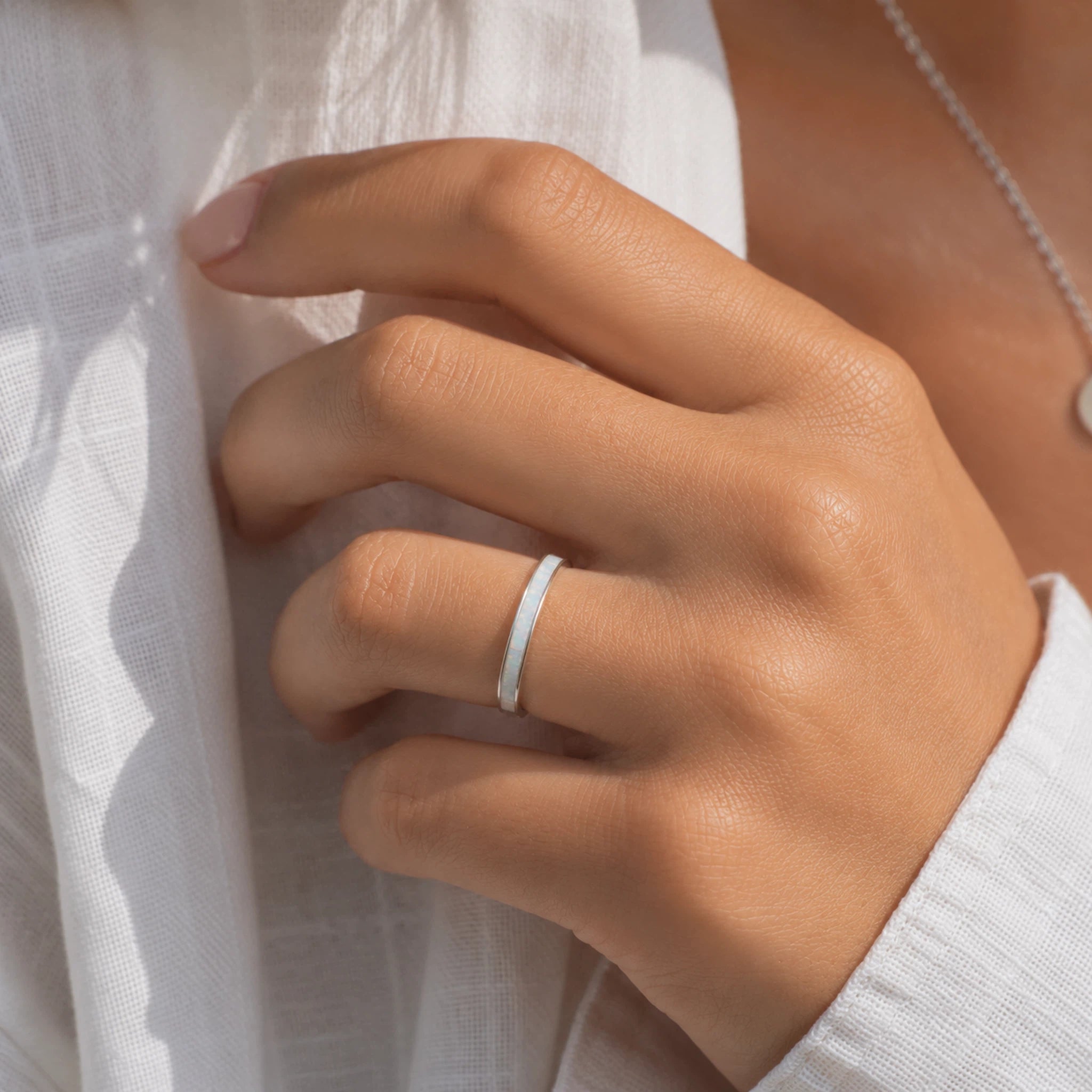 models hand wearing a sterling white opal inlay ring