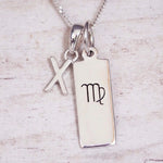 sterling silver initial x virgo zodiac star sign pendant necklace against a light wooden background