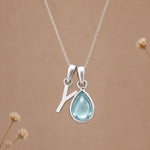 Sterling silver Y initial necklace with pale blue March aquamarine in a polished teardrop bezel