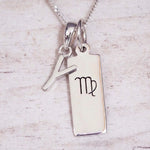 sterling silver initial y virgo zodiac star sign pendant necklace against a light wooden background