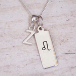 sterling silver initial z leo zodiac star sign pendant necklace against a light wooden background