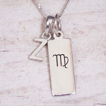 sterling silver initial z virgo zodiac star sign pendant necklace against a light wooden background