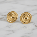 Gold earrings on a marble background