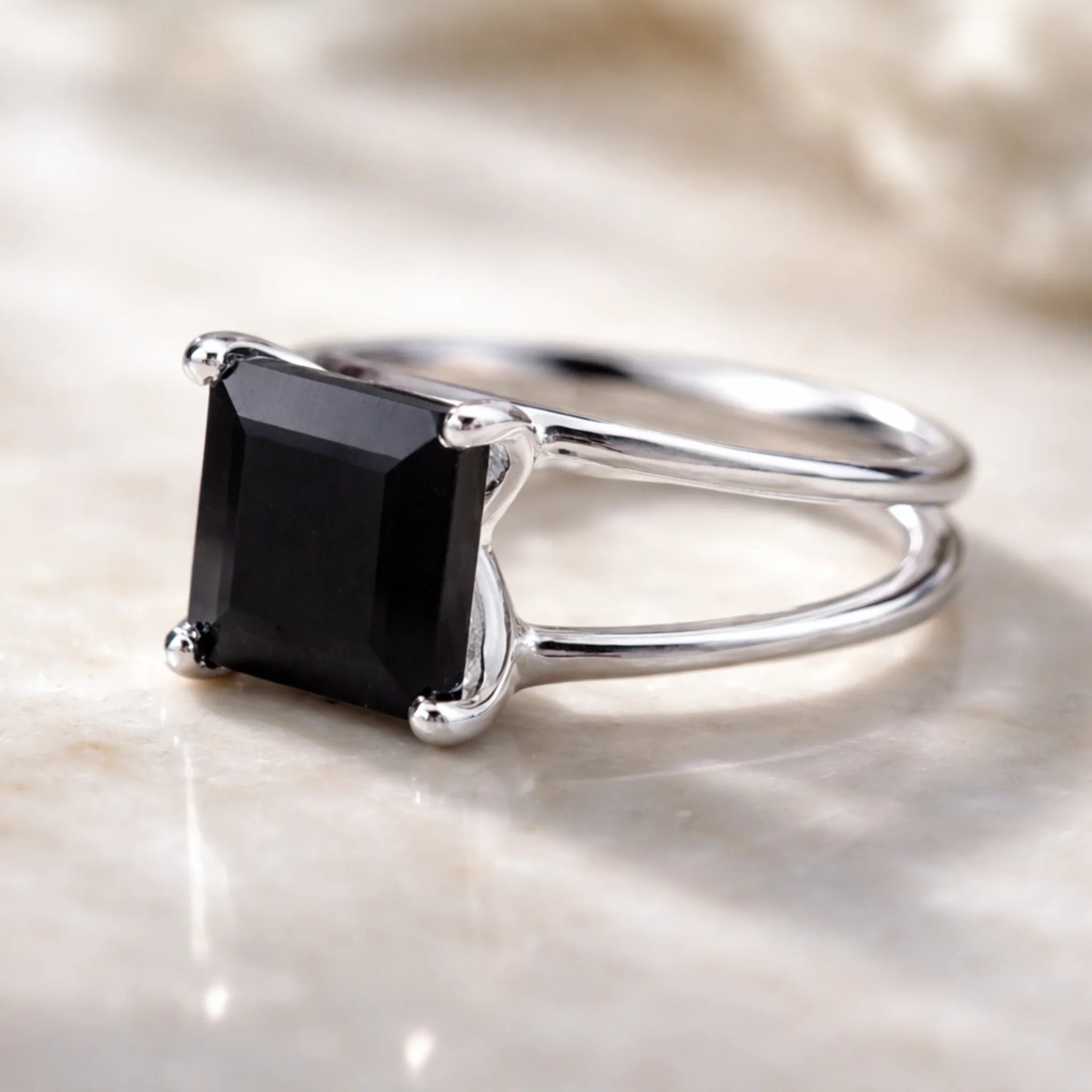 Sterling Silver ring with a black onyx gemstone on a marble surface