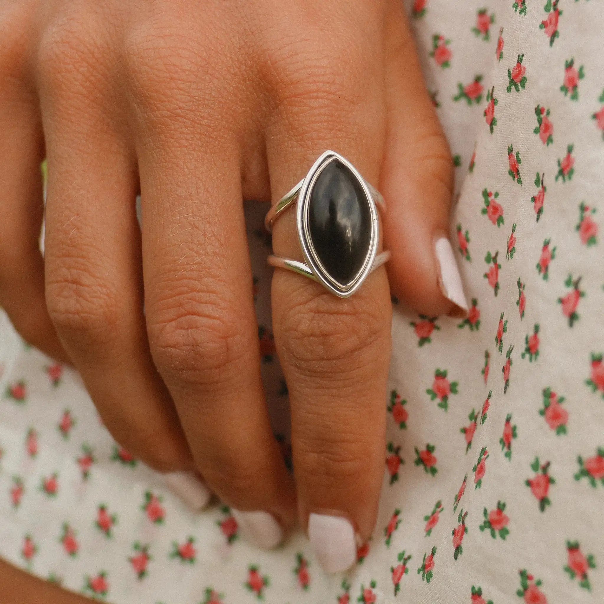 woman wearing a white dress with red flowers and wearing a sterling silver statement black onyx ring - boho jewellery by Australian jewellery brands online indie and Harper