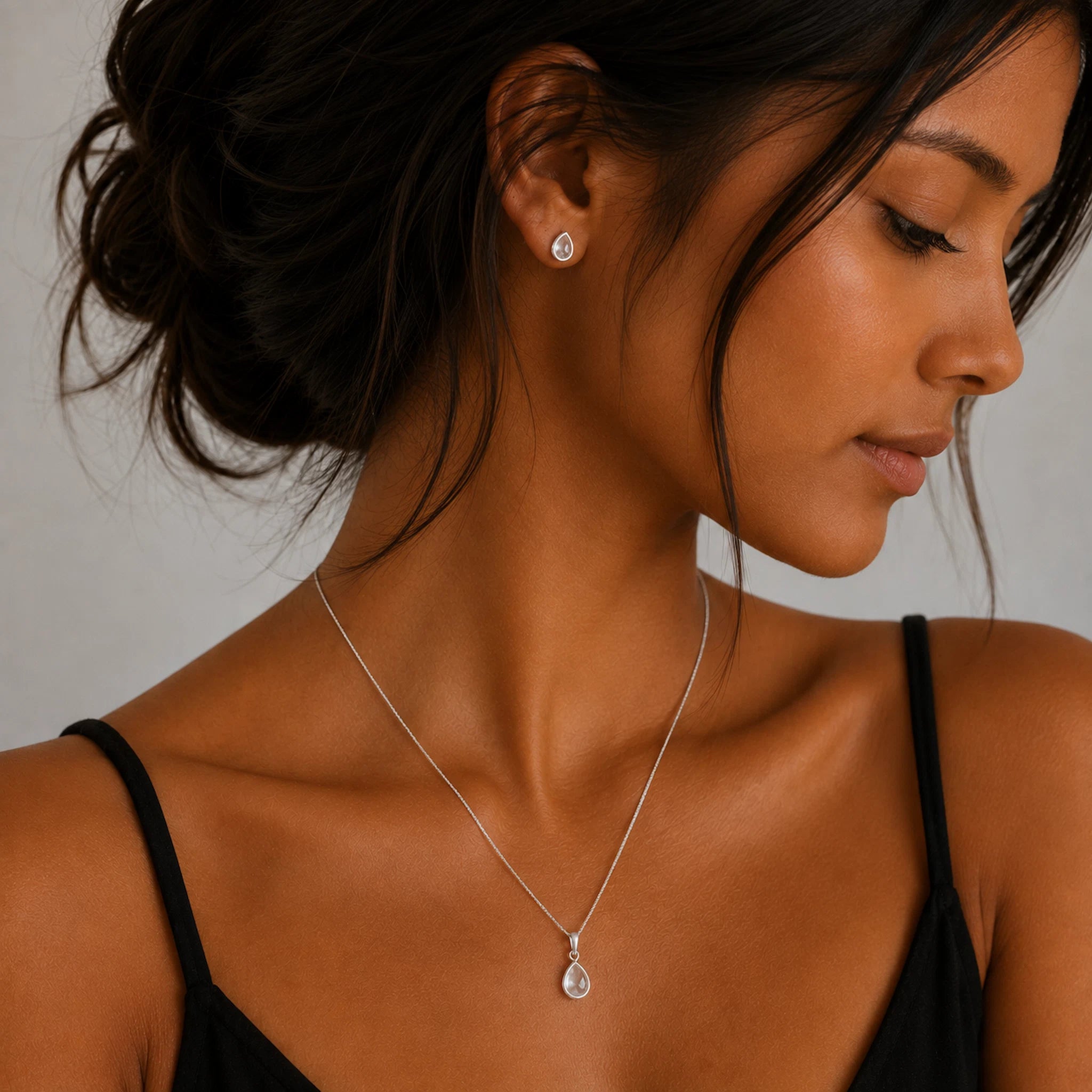 model wearing a Sterling Silver April Birthstone Jewellery set featuring Clear Quartz Stud Earrings and matching Clear Quartz pendant necklace