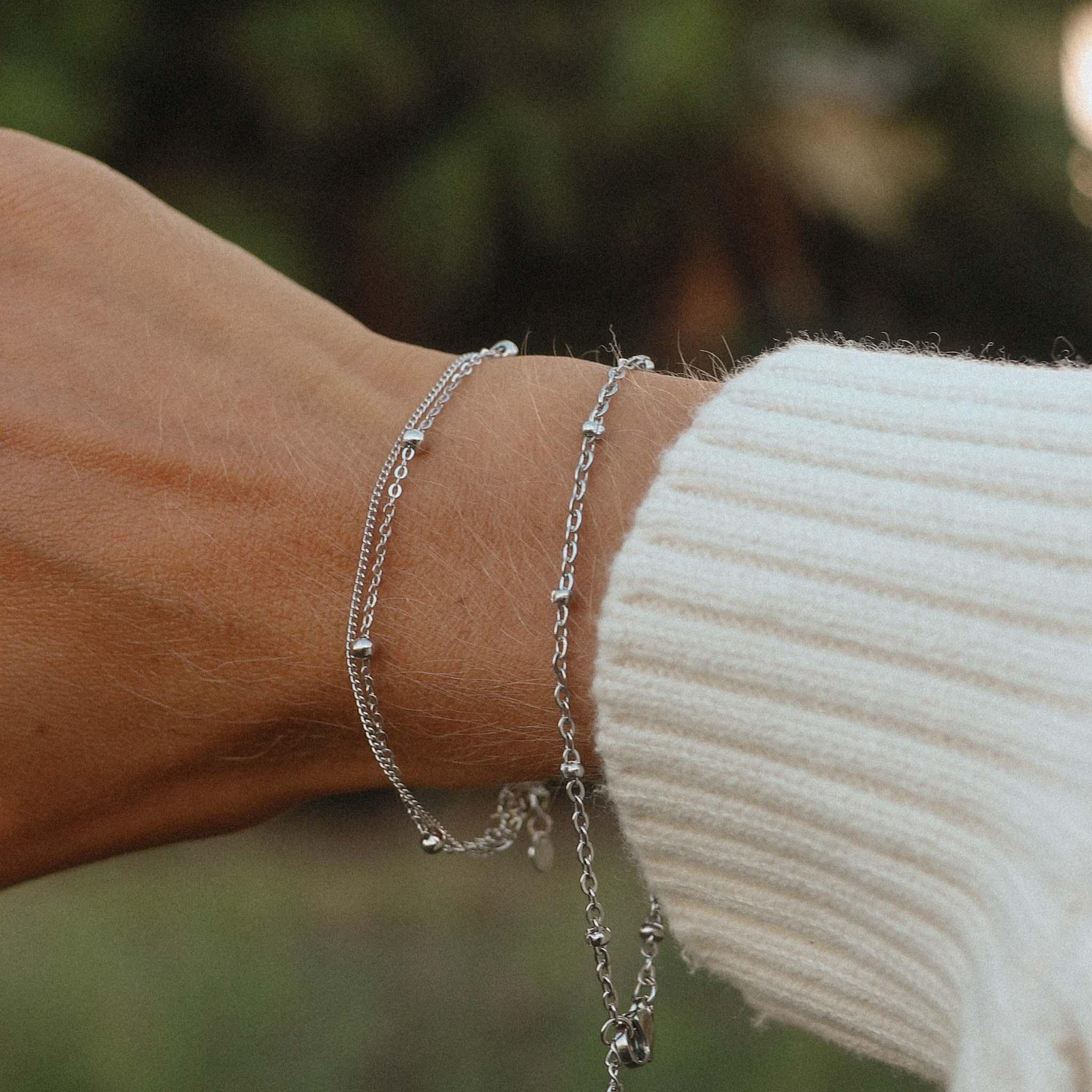 Woman with white jumper wearing Sterling Silver Bracelets