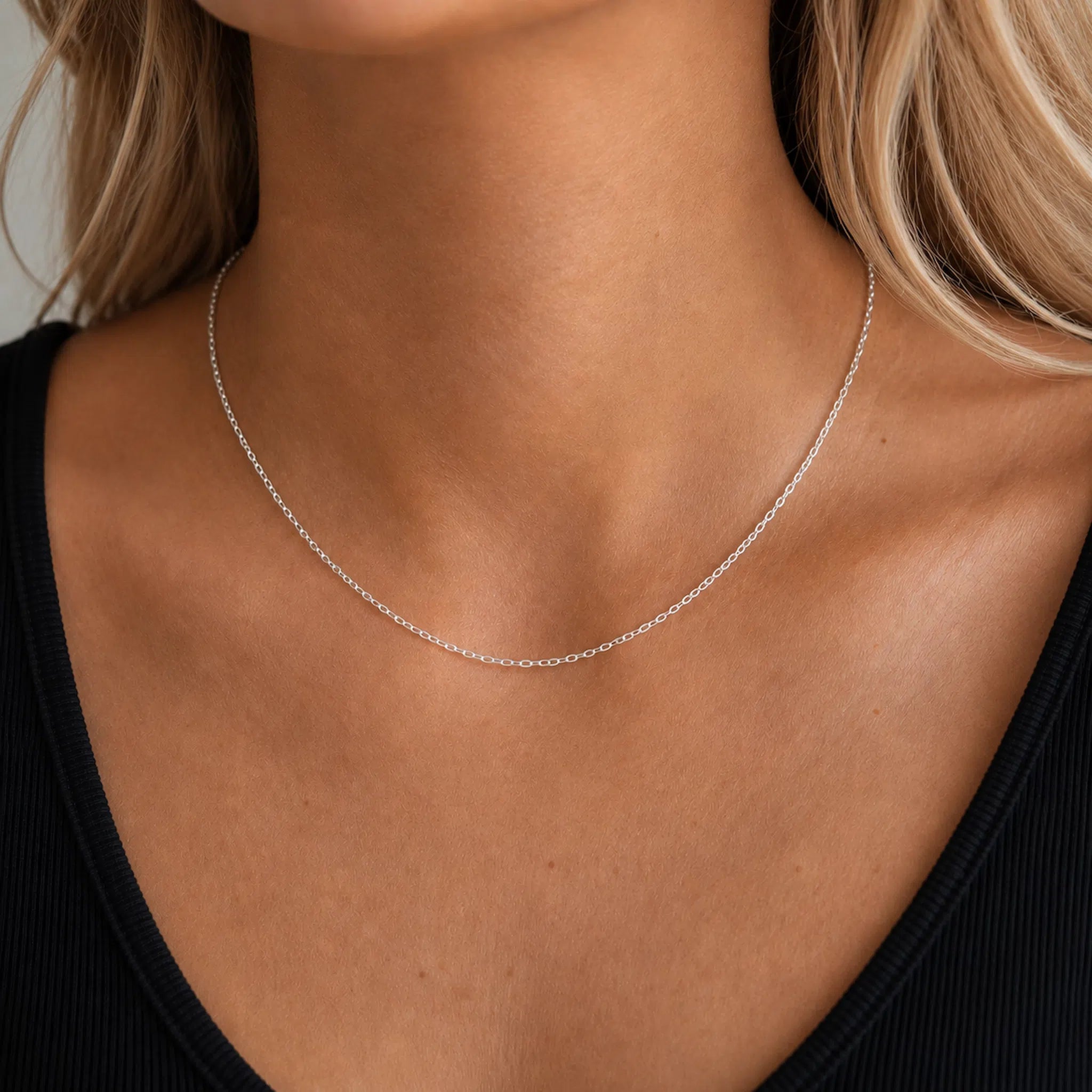 sterling Silver cable chain necklace on a person wearing a black top