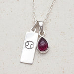 sterling silver necklace with a silver cancer zodiac pendant and silver tear drop ruby gemstone pendant