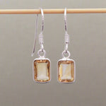 sterling silver french hook earrings with bezel-set and emerald-cut natural citrine gemstones hanging