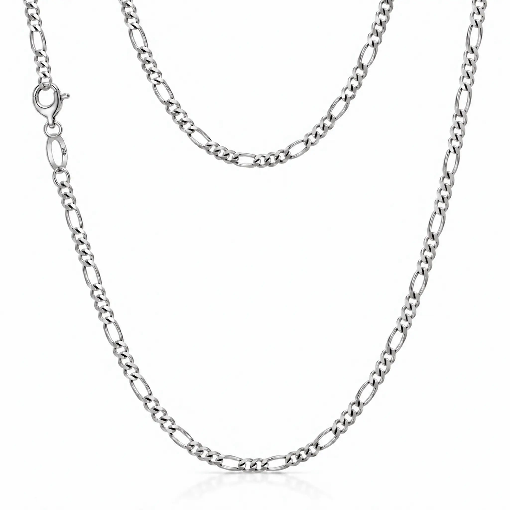 A silver Figaro chain necklace with a lobster clasp, displayed in a layered drape on a clean white background.