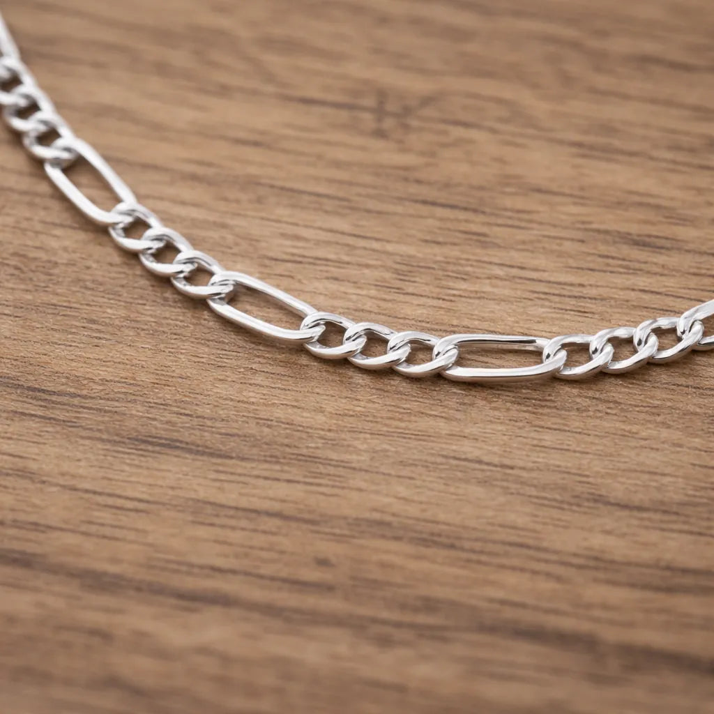Silver chain necklace on a wooden surface
