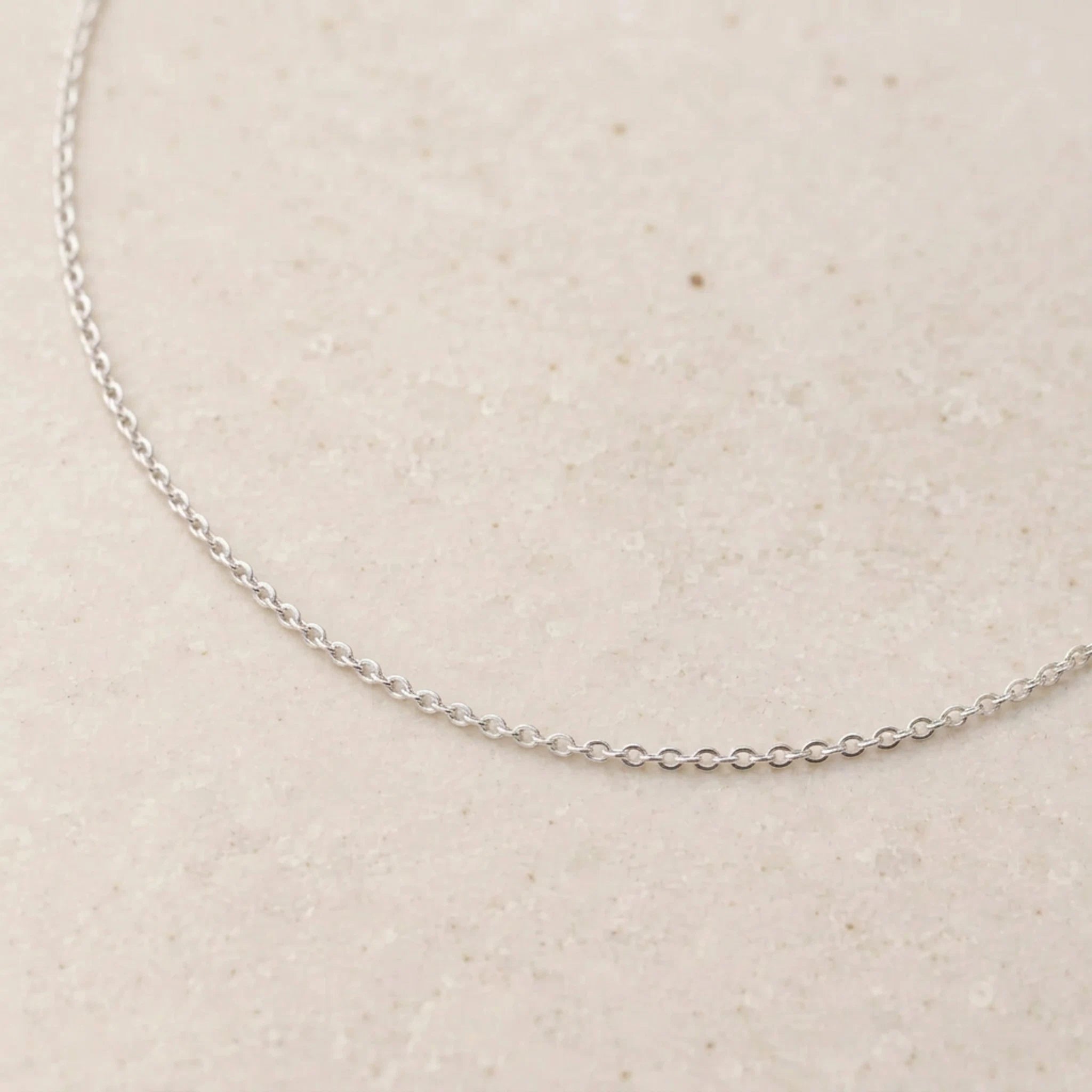close up of a sterling silver fine cable chain necklace