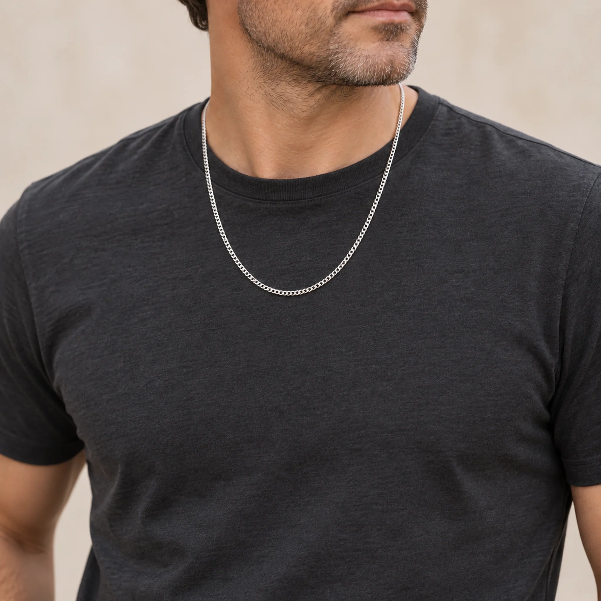 Sterling silver 24 inch flat curb chain, 1.5 mm, worn by a man over a charcoal T-shirt
