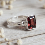 sterling Silver garnet ring with a natural garnet gemstone on a light surface