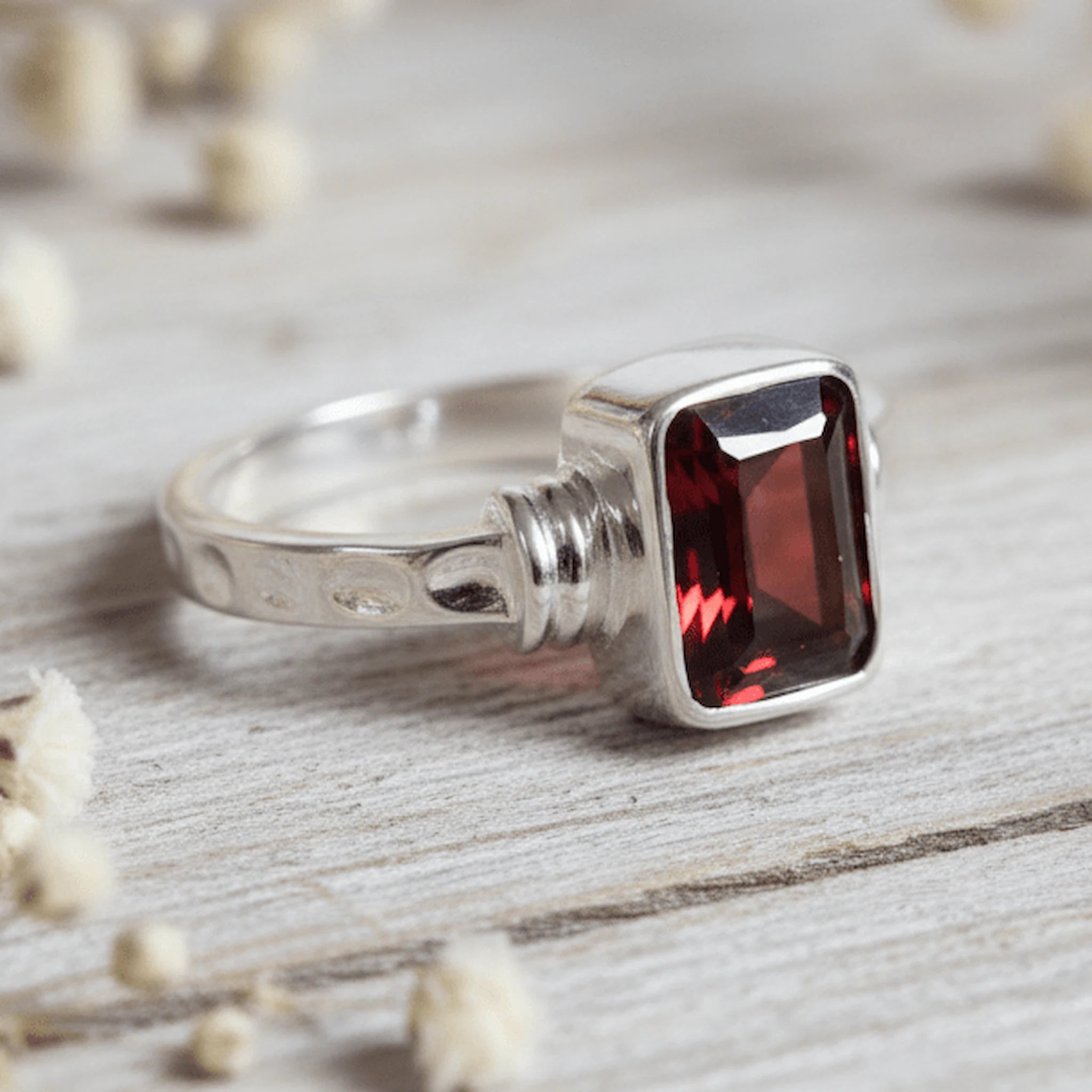 sterling Silver garnet ring with a natural garnet gemstone on a light surface