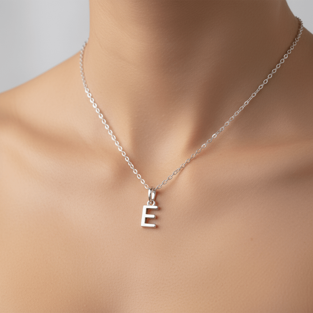 Silver necklace with a 'E' pendant on a mannequin