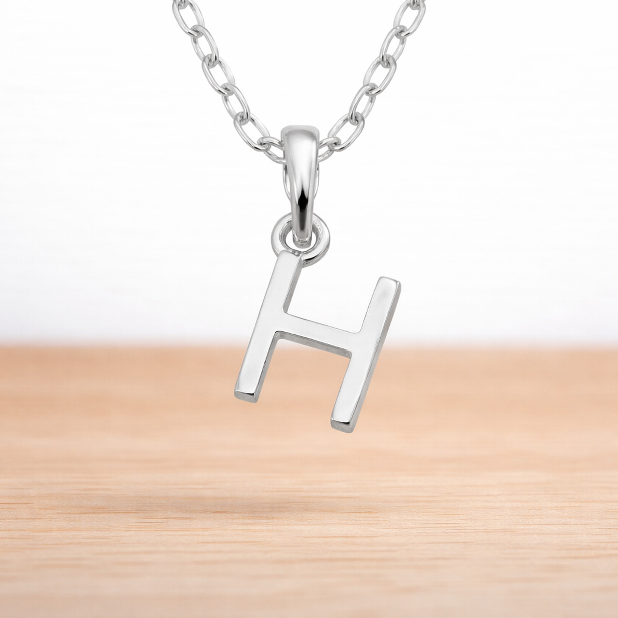 Sterling Silver necklace with a 'H' initial pendant on a white background