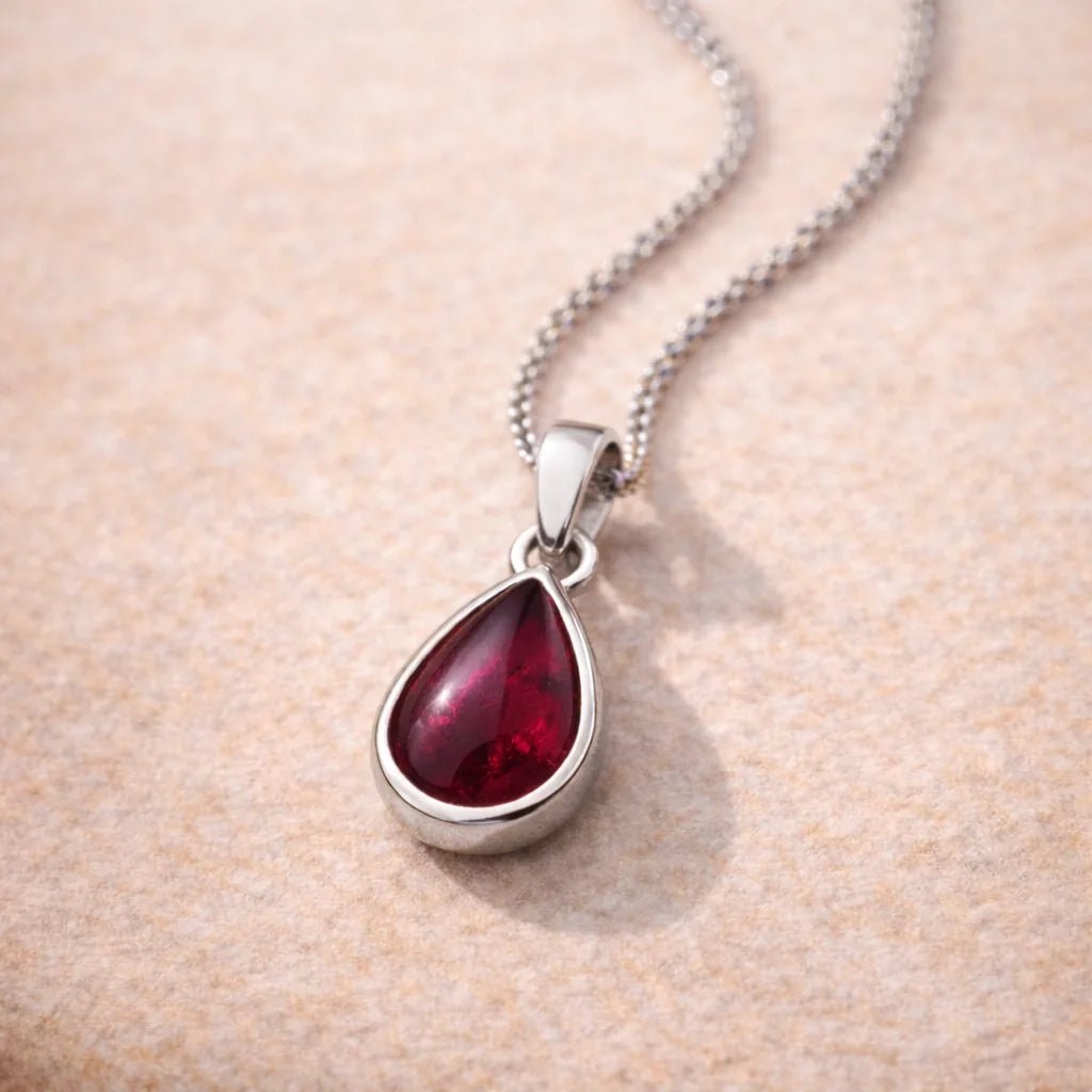 Sterling Silver January Birthstone Necklace with a teardrop-shaped pendant with red natural garnet gemstone