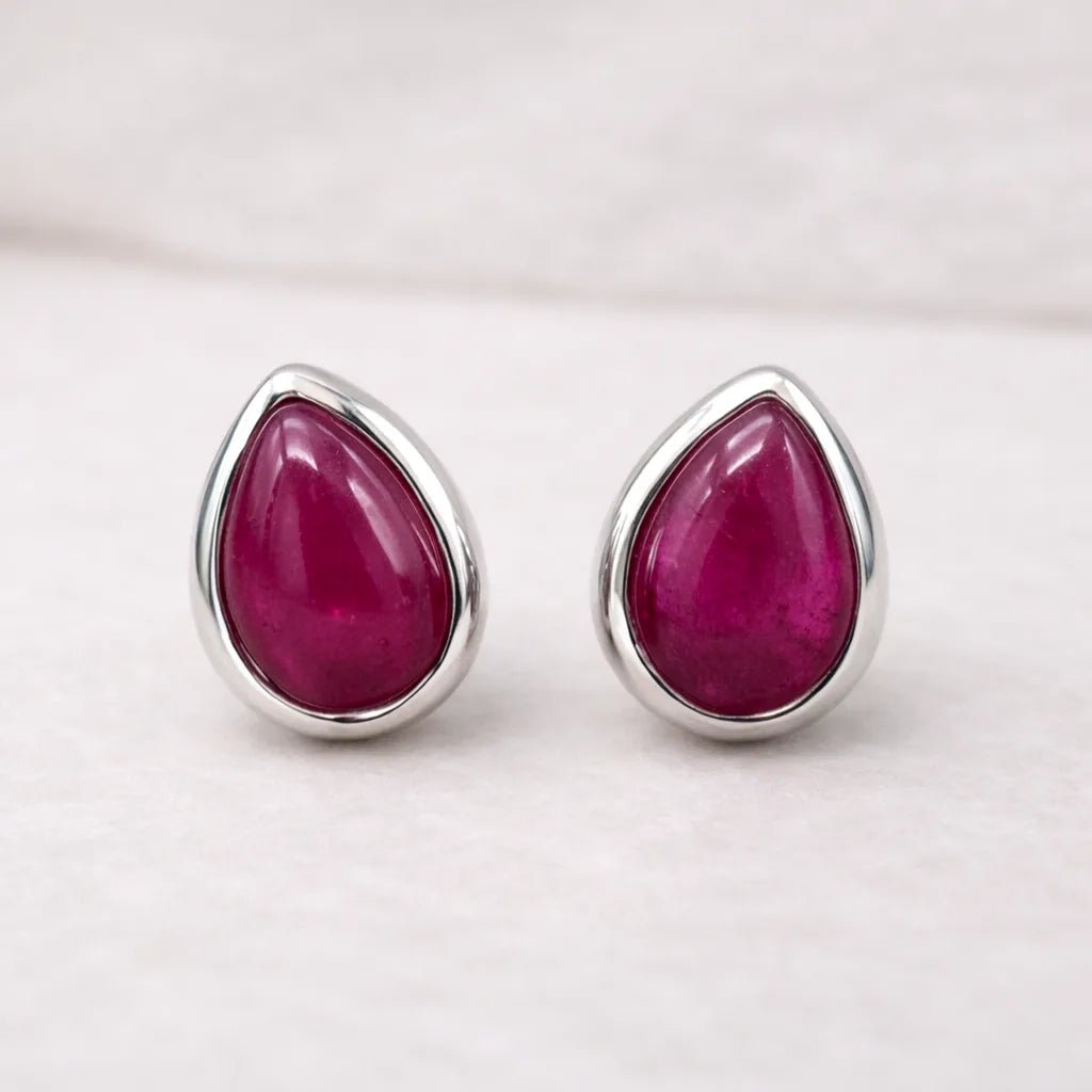 July birthstone Teardrop-shaped natural ruby stud earrings with a light background