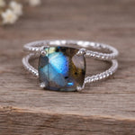 Sterling Silver ring with a natural Labradorite gemstone on a wooden surface