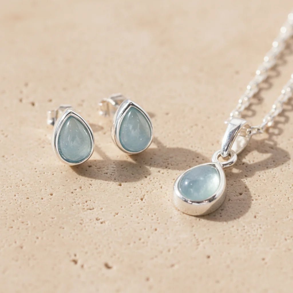 March birthstone aquamarine jewellery set in 925 sterling silver featuring teardrop aquamarine pendant necklace and matching aquamarine stud earrings