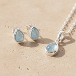 March birthstone aquamarine jewellery set in 925 sterling silver featuring teardrop aquamarine pendant necklace and matching aquamarine stud earrings