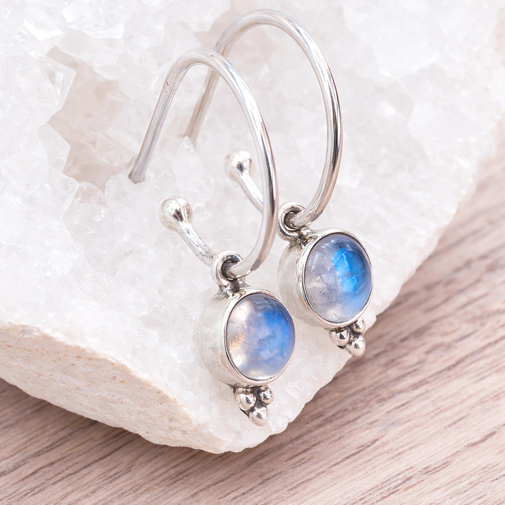 Sterling Silver Moonstone hoop earrings  on a white stone surface