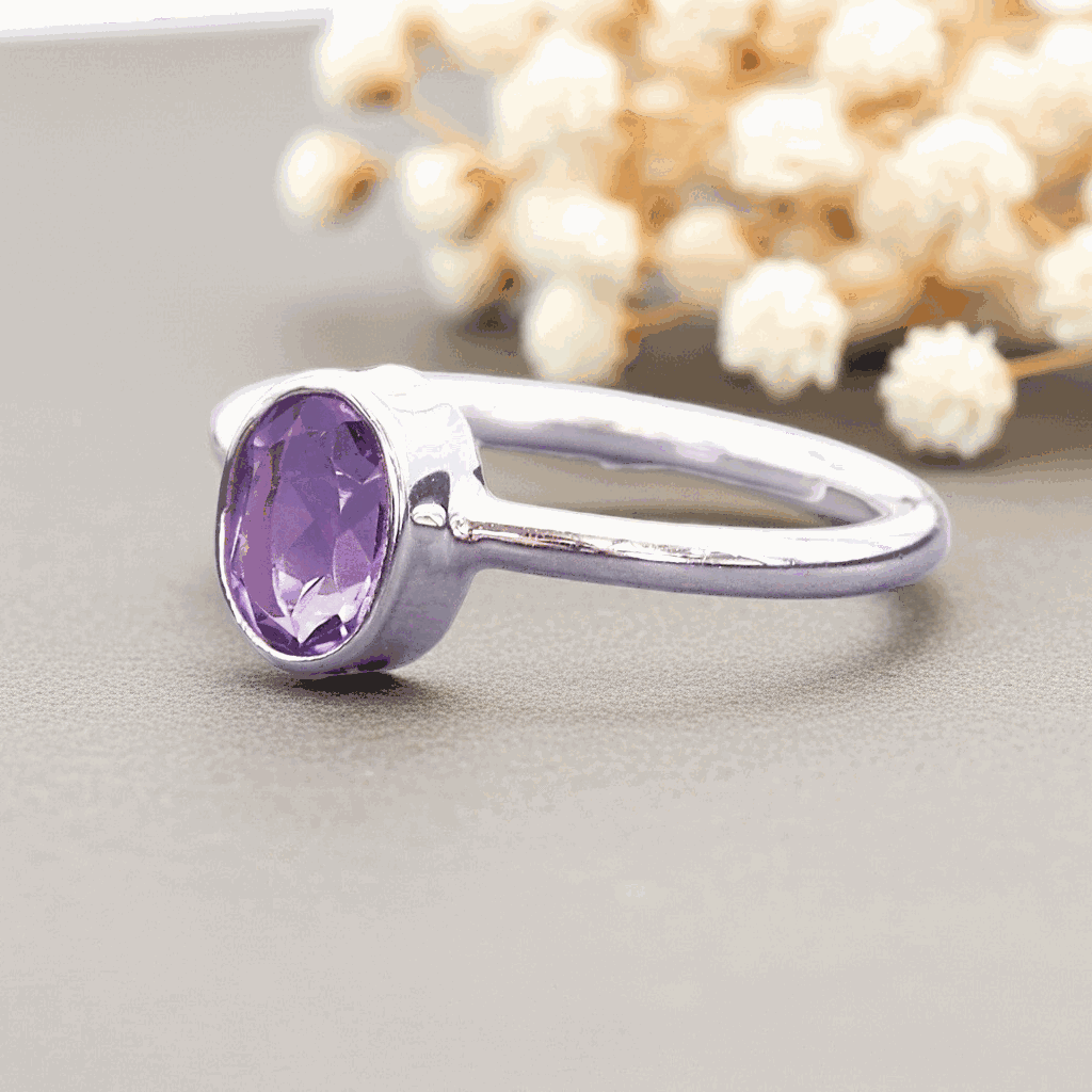 Sterling Silver ring with a purple amethyst gemstone on a neutral background