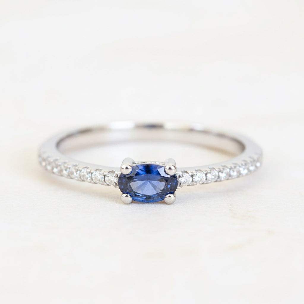 sterling silver Ring with a blue sapphire gemstone and czs accents on a textured surface