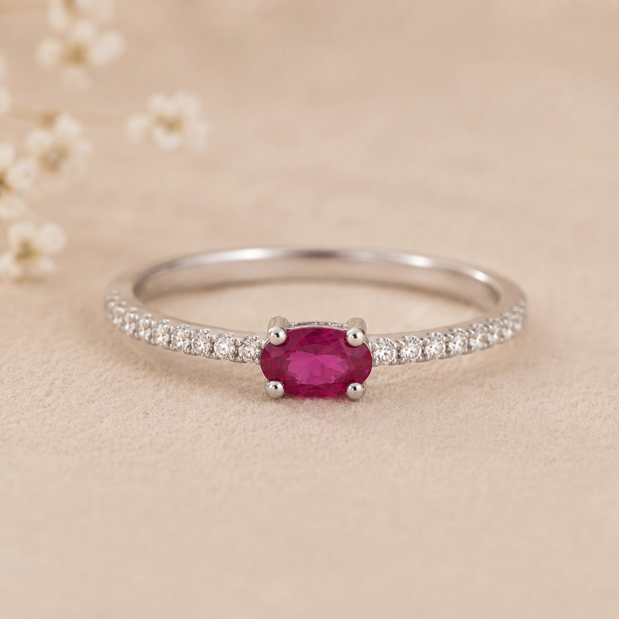 sterling Silver ring with a red natural ruby gemstone on a beige background