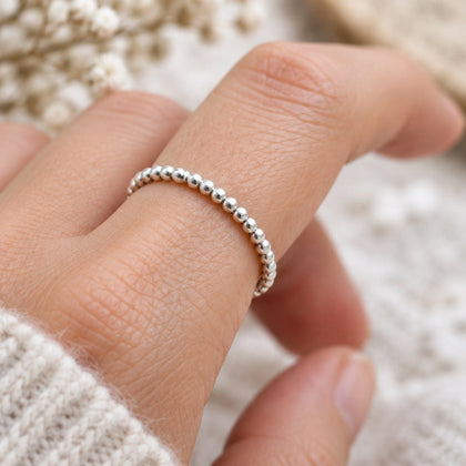 Sterling silver beaded stacker ring on a finger
