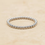 Sterling Silver beaded stacker ring on a beige background
