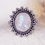 Sterling Silver ring with a natural moonstone gemstone on a textured white surface