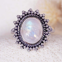 Sterling Silver ring with a natural moonstone gemstone on a textured white surface