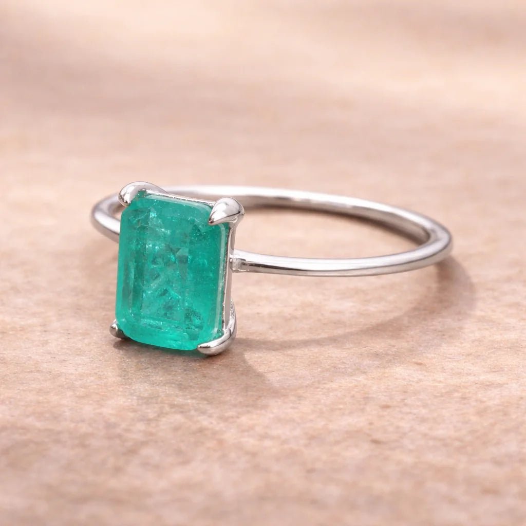 sterling silver ring with a green blue natural tourmaline gemstone on a neutral background
