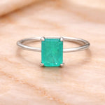 Sterling Silver ring with a natural green blue tourmaline gemstone on a wooden surface