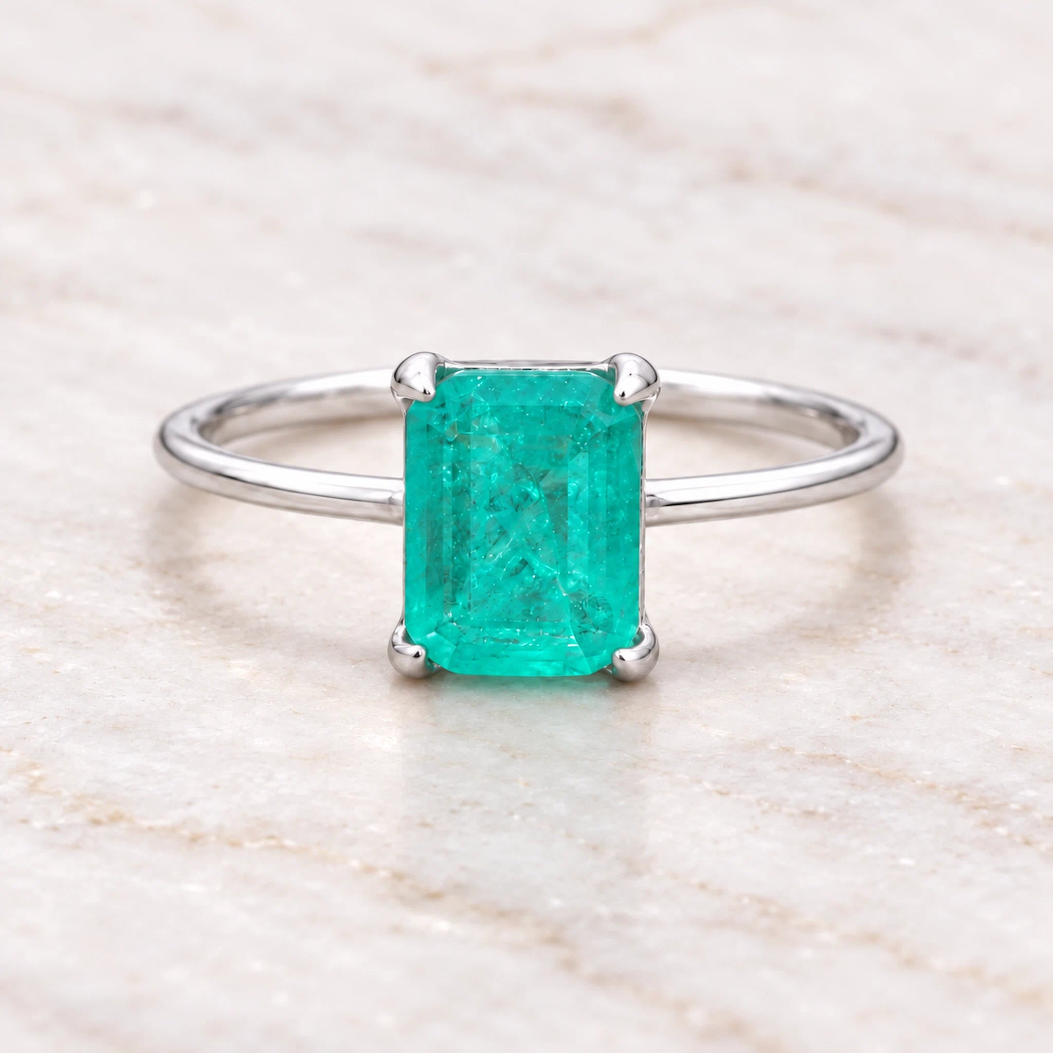 Sterling Silver ring with a natural green blue tourmaline gemstone on a wooden surface