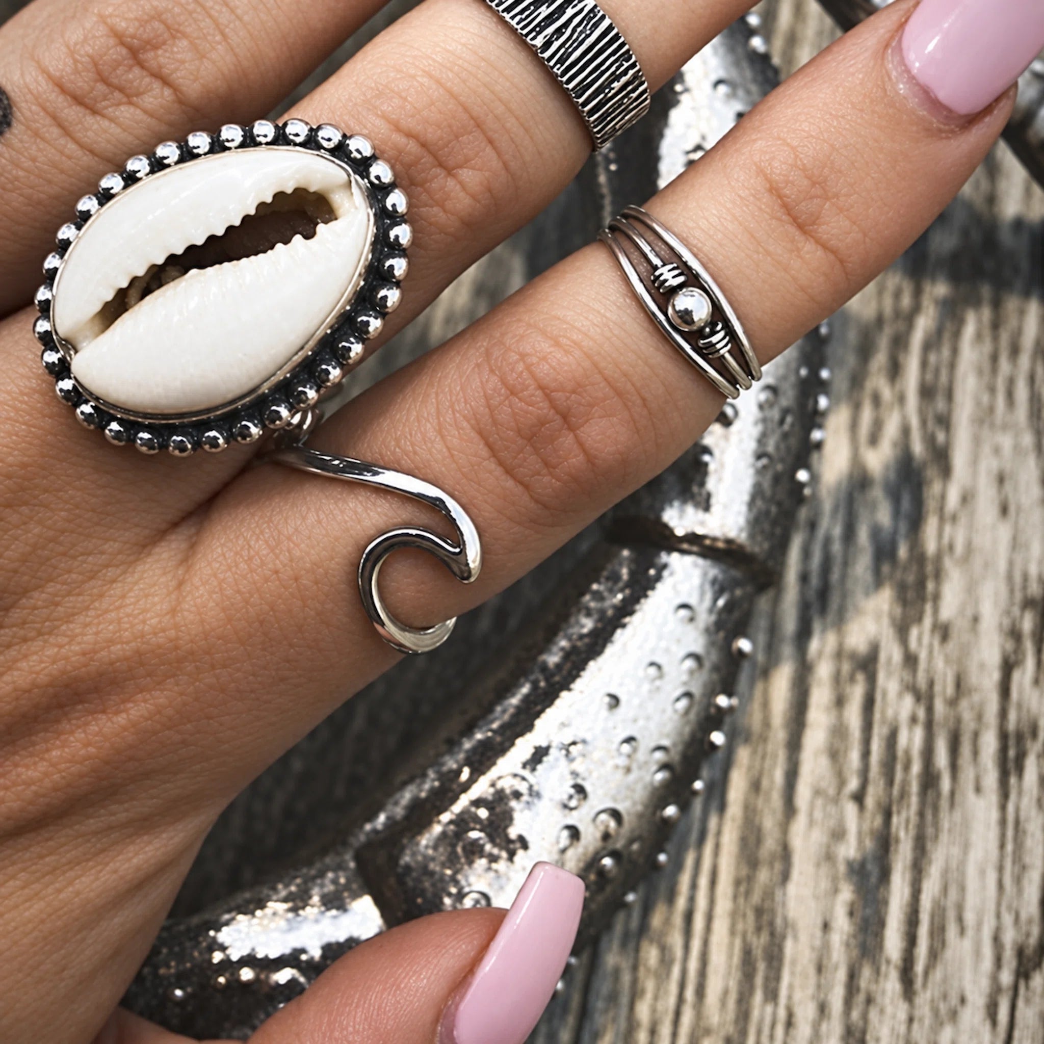 sterling silver wave ring and Cowrie Shell Ring being worn