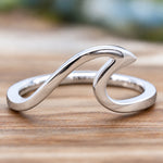 indie and harpers sterling silver wave ring on a wooden surface