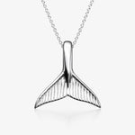 sterling Silver whale tail pendant on a white background