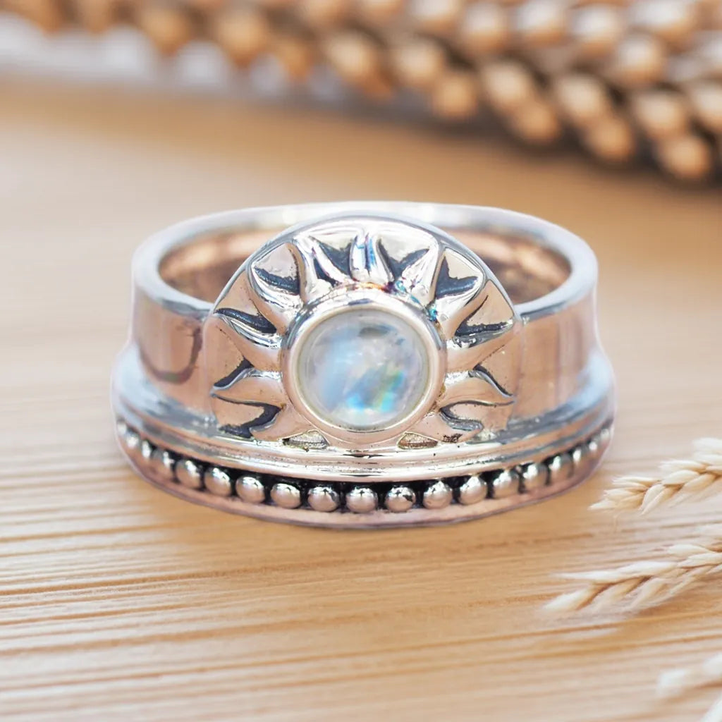 Silver ring with moonstone on a wooden surface