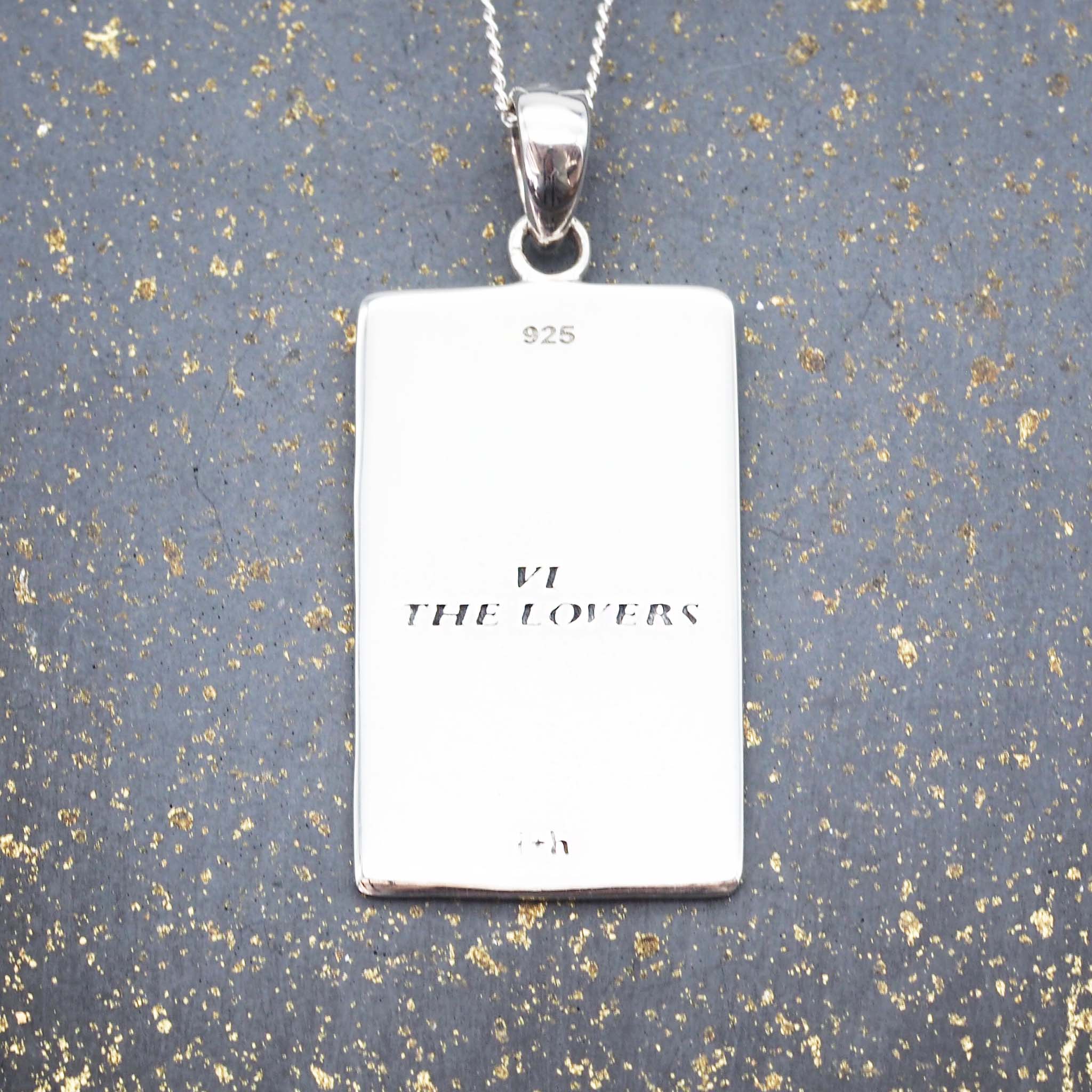 the lovers tarot card necklace with english translation on the back of the pendant by online jewellery brand indie and harper