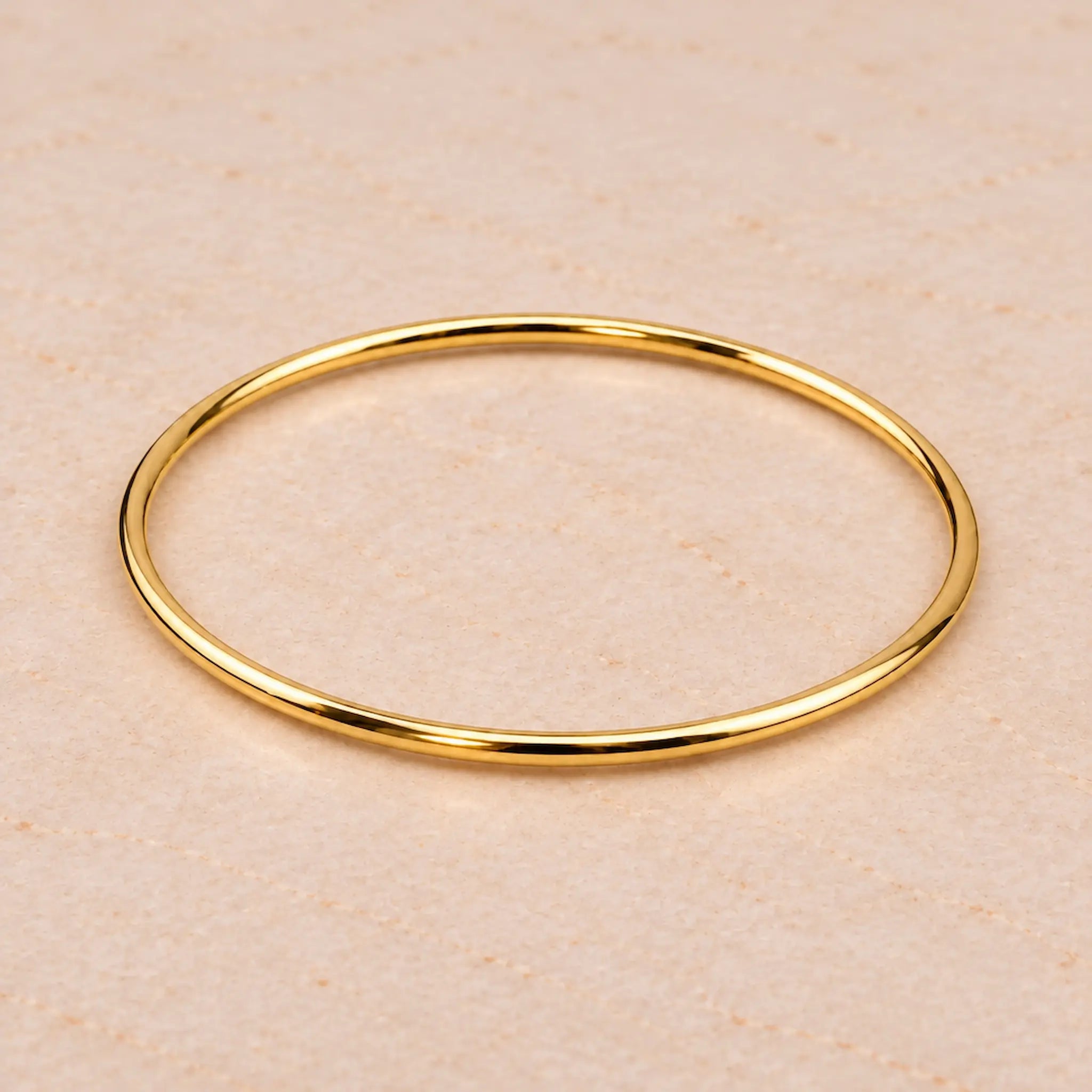 Thin 3mm gold bangle bracelet in PVD plated waterproof stainless steel